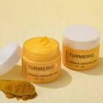 Turmeric+ Face Cream by Lanthome in an open jar, featured on Rosvia, shown with turmeric powder on a wooden spoon.