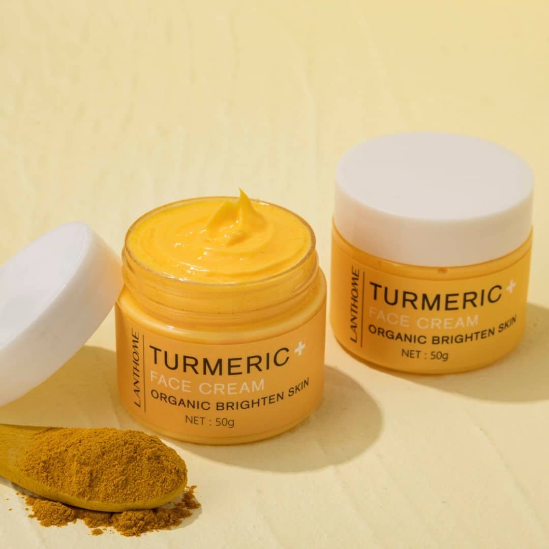turmeric-face-cream-open-jar-rosvia Turmeric+ Face Cream by Lanthome in an open jar, featured on Rosvia, shown with turmeric powder on a wooden spoon.